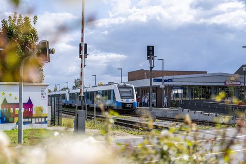 Der Bahnhof in Neuenhaus mit einem einfahrenden Zug. Fotografiert aus der Richtung von Porsten Börse
